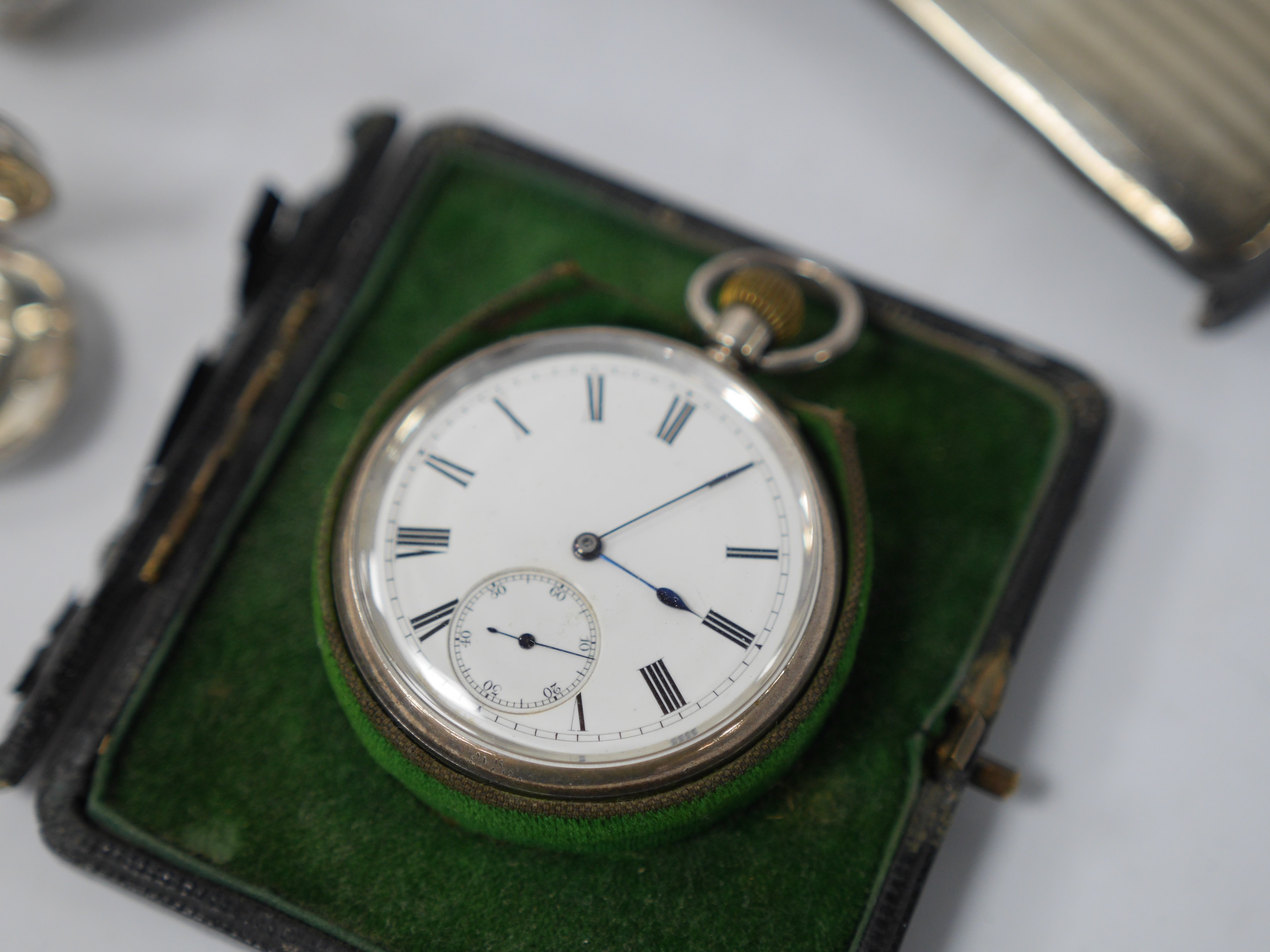 A George V silver sovereign/half sovereign case, by George Unite & Sons, Birmingham, 1911, 59mm, together with an Edwardian silver miniature free-standing model of a bird spice box with detachable head, import marks for